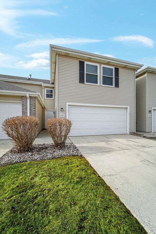 traditional home with concrete driveway and an attached garage