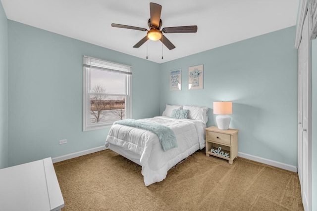 carpeted bedroom with a ceiling fan and baseboards