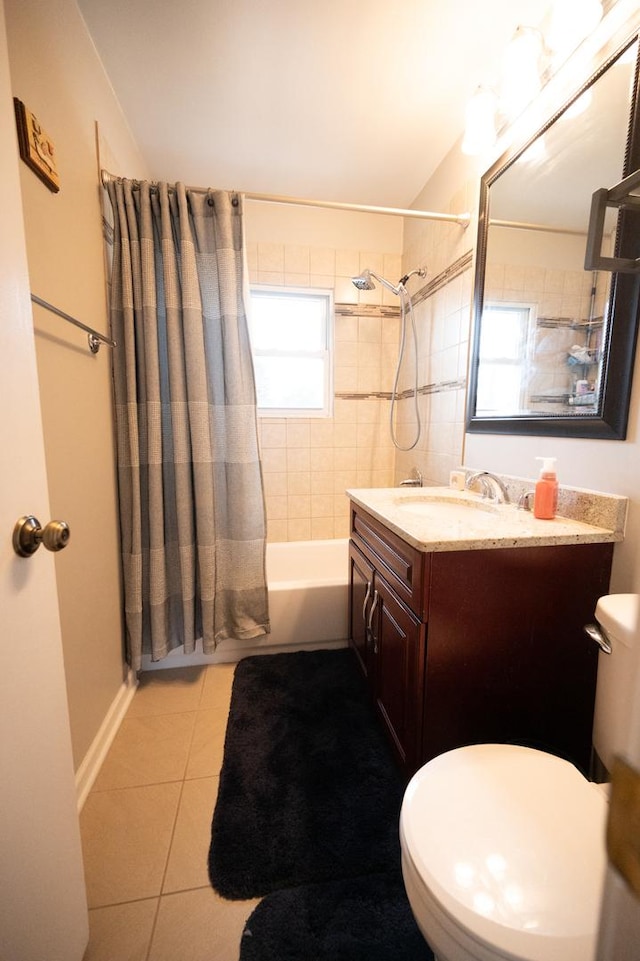 bathroom featuring shower / tub combo, baseboards, toilet, tile patterned floors, and vanity