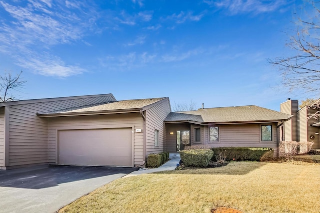 ranch-style house with a garage, driveway, roof with shingles, and a front yard