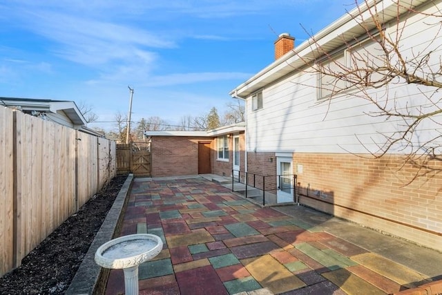 view of patio featuring fence private yard and a gate