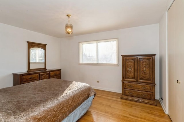 bedroom with baseboards and light wood-style floors