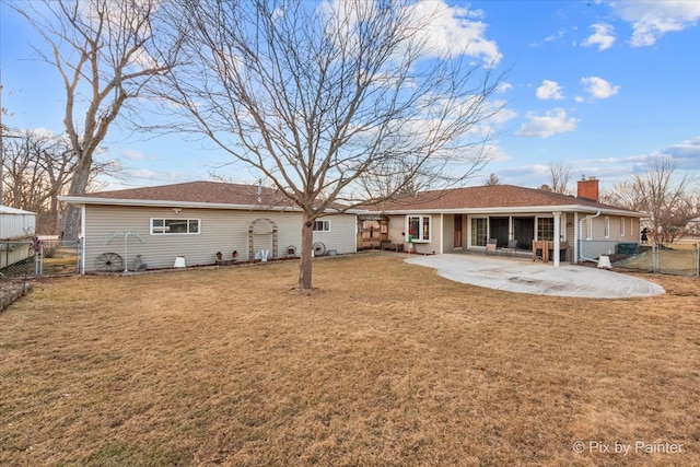 back of property with a gate, a patio area, a yard, and fence