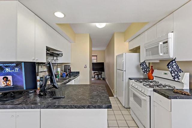 kitchen with white appliances, light tile patterned floors, dark countertops, under cabinet range hood, and white cabinetry