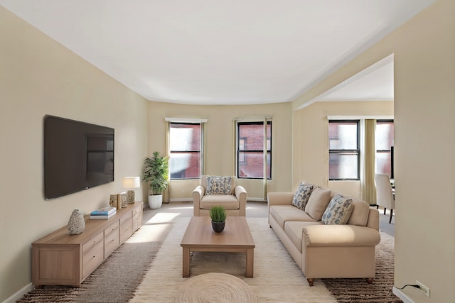 living area with a healthy amount of sunlight and baseboards