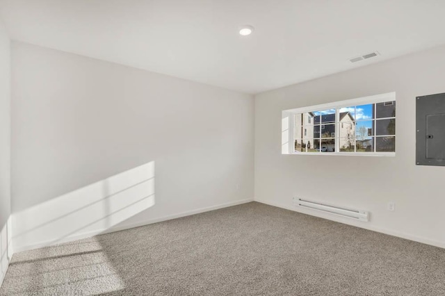 unfurnished room featuring a baseboard heating unit, electric panel, visible vents, and carpet flooring