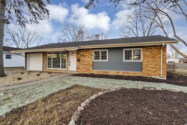 ranch-style home featuring a garage and brick siding