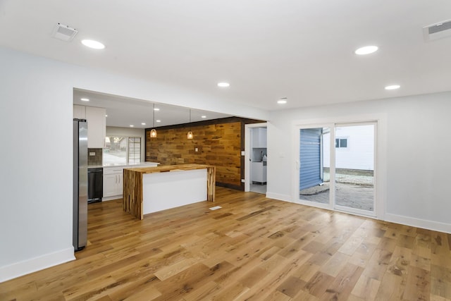 kitchen featuring pendant lighting, visible vents, white cabinetry, wood counters, and light wood-type flooring