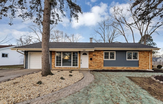 ranch-style home featuring aphalt driveway, brick siding, a shingled roof, and a garage