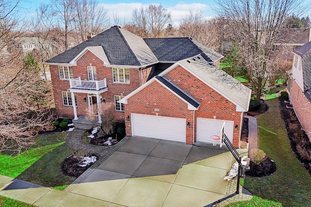 view of front facade featuring a balcony, brick siding, concrete driveway, roof with shingles, and a chimney