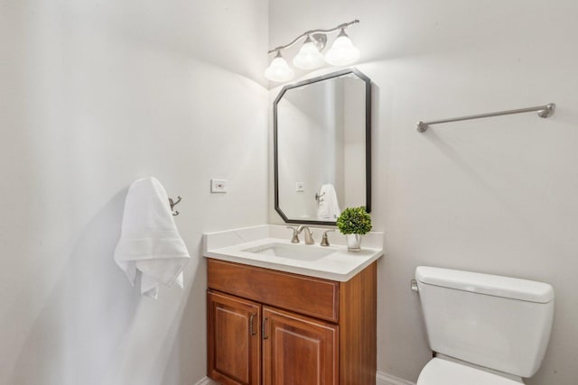 half bathroom with toilet and vanity