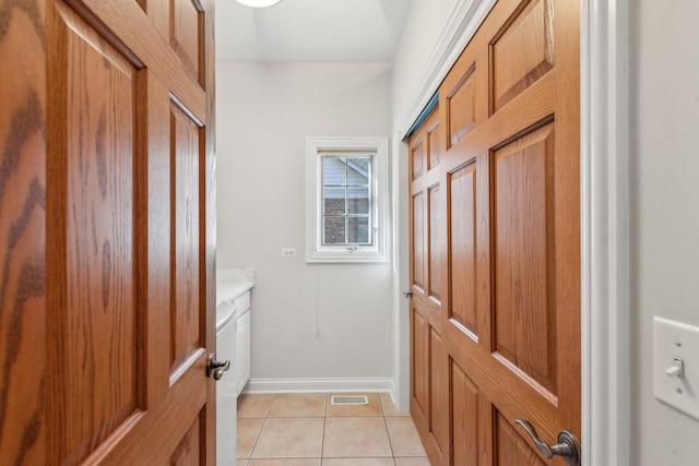 entryway with light tile patterned floors, visible vents, and baseboards