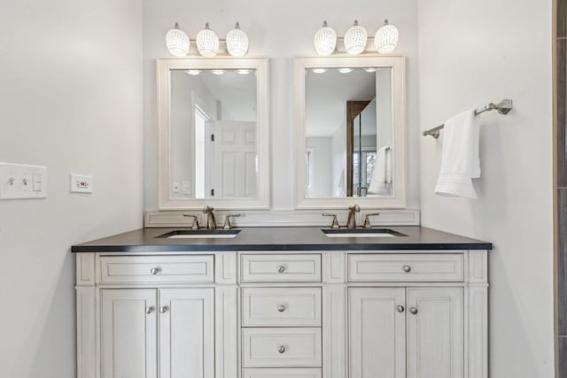 full bathroom with double vanity and a sink