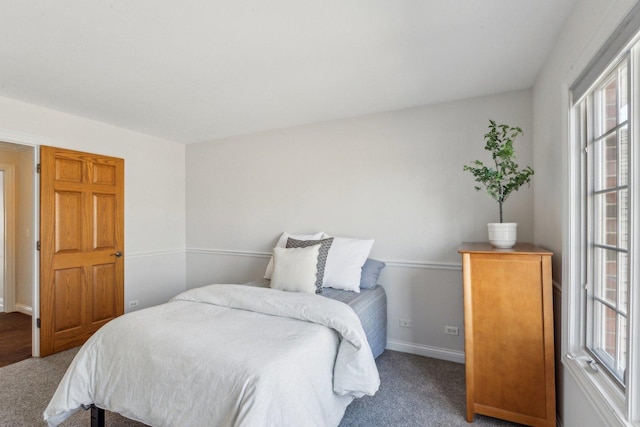 bedroom featuring carpet and baseboards