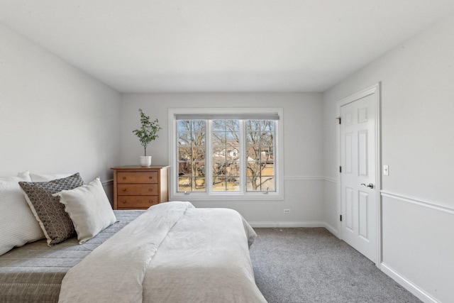 bedroom with carpet floors and baseboards