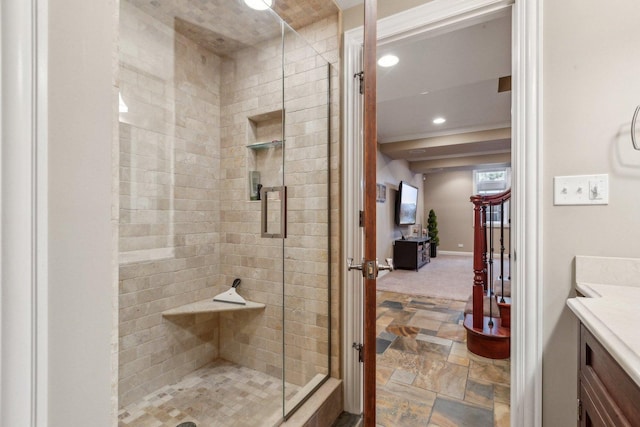 full bath with recessed lighting, vanity, baseboards, stone finish flooring, and a stall shower