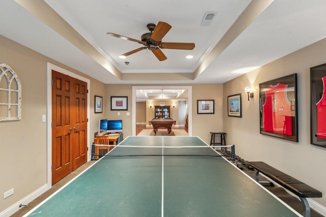 recreation room featuring recessed lighting, visible vents, baseboards, ornamental molding, and a tray ceiling