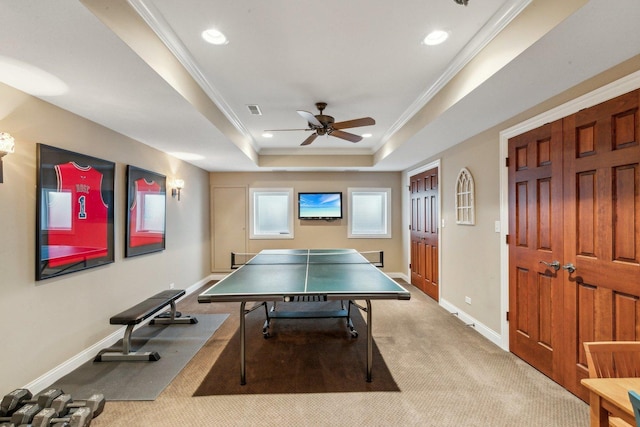 rec room featuring recessed lighting, carpet flooring, baseboards, a raised ceiling, and crown molding