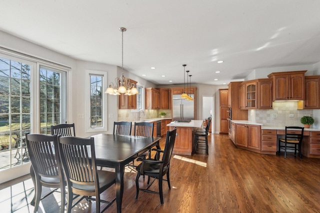 dining room with dark wood finished floors, a notable chandelier, and recessed lighting