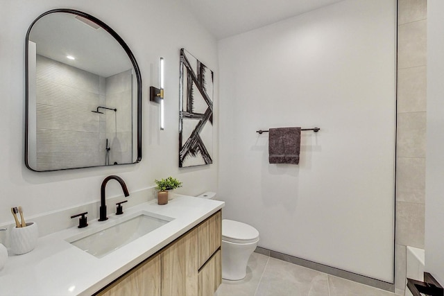 full bathroom featuring vanity, a tile shower, toilet, and tile patterned floors