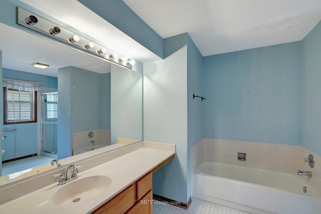 full bathroom with tile patterned flooring, a garden tub, vanity, and a shower stall