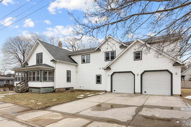 traditional-style home with driveway, a garage, a sunroom, a chimney, and roof with shingles