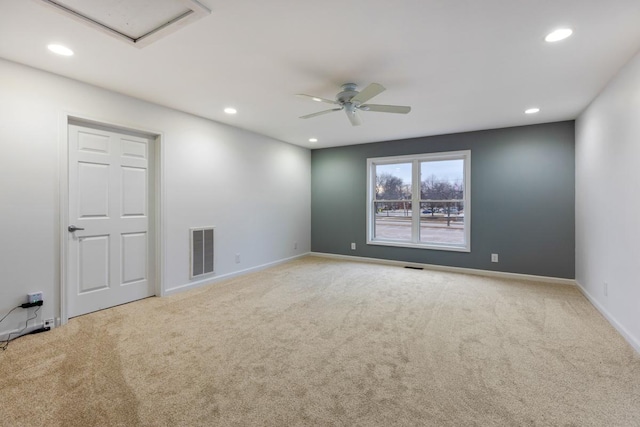 empty room with carpet floors, visible vents, and recessed lighting