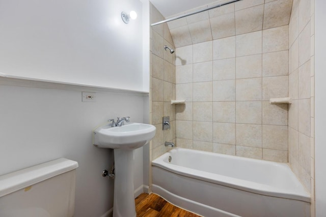 full bathroom with a sink, shower / bathing tub combination, toilet, and wood finished floors