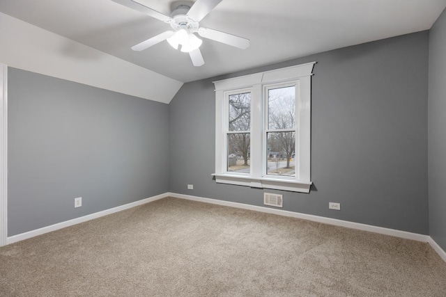 additional living space featuring lofted ceiling, ceiling fan, carpet flooring, visible vents, and baseboards