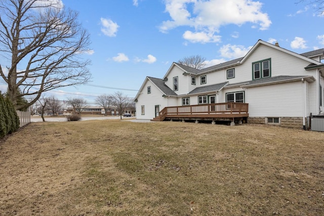 rear view of property with a yard, fence, a wooden deck, and central air condition unit