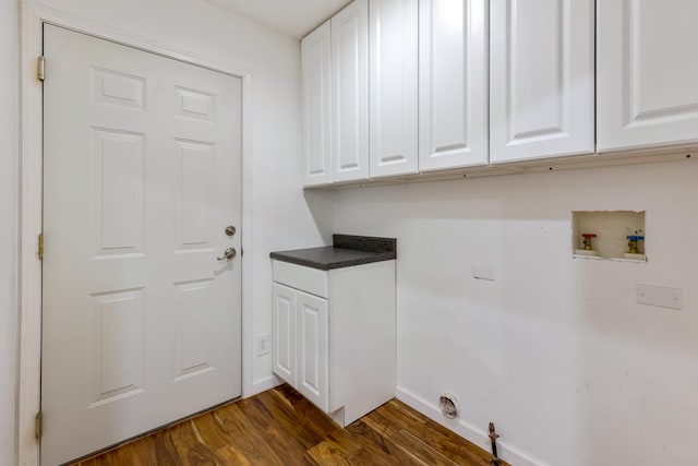 laundry room featuring cabinet space, baseboards, dark wood-style floors, and washer hookup