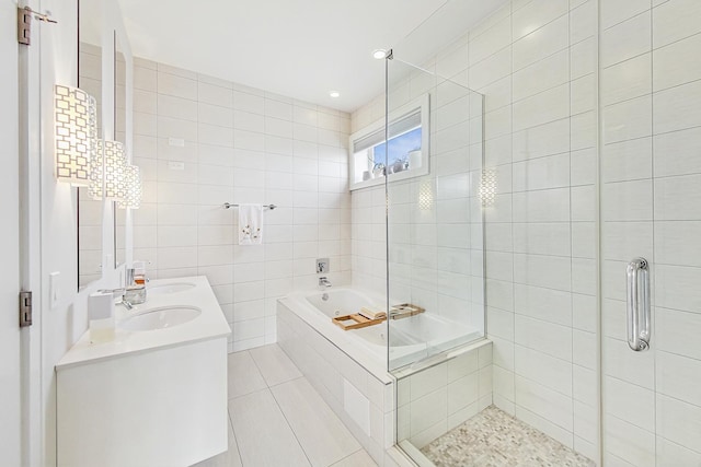 full bathroom with a garden tub, a sink, tile walls, a shower stall, and double vanity