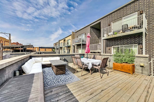 wooden terrace featuring outdoor lounge area and outdoor dining space