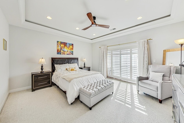 bedroom with access to exterior, visible vents, and a raised ceiling