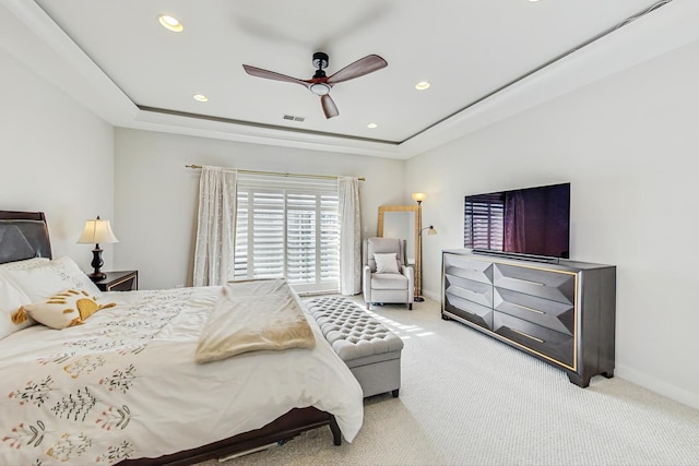 carpeted bedroom with a tray ceiling, recessed lighting, a ceiling fan, and baseboards