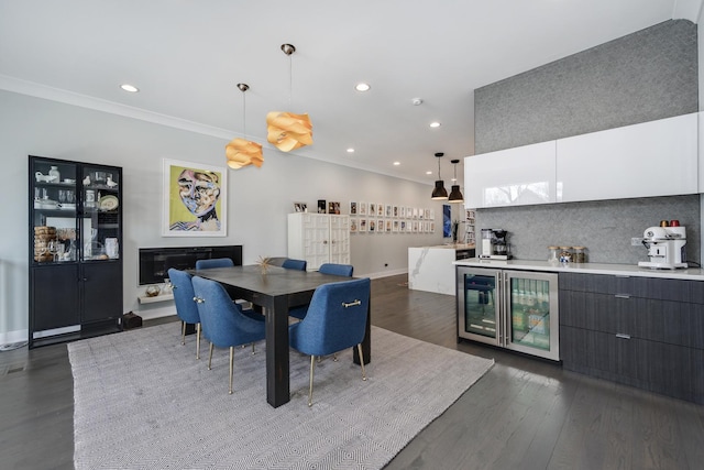 dining area with a dry bar, ornamental molding, dark wood-style flooring, and recessed lighting