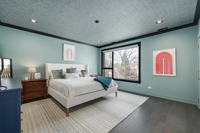 bedroom featuring dark wood-style flooring, crown molding, visible vents, a textured ceiling, and baseboards