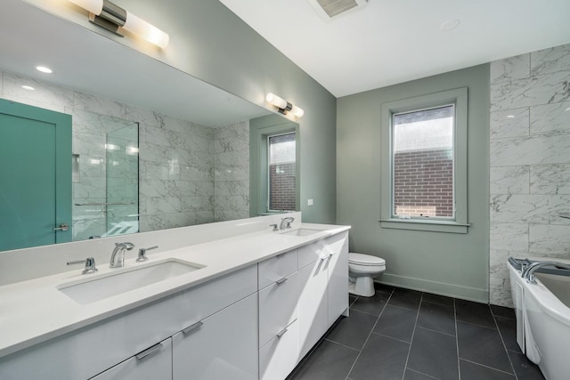 bathroom with double vanity, visible vents, toilet, a tub, and a sink