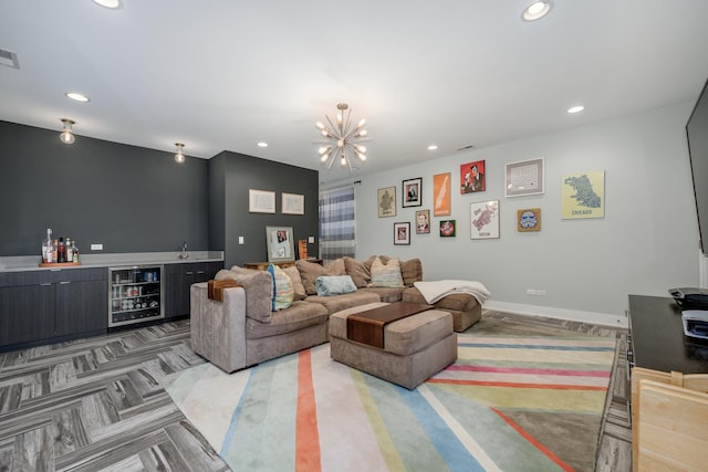 living room featuring beverage cooler, baseboards, bar, and recessed lighting