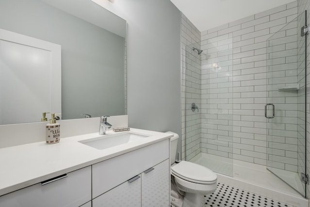 bathroom featuring a shower stall, vanity, and toilet