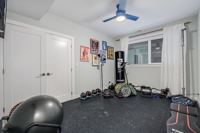 workout area with ceiling fan and baseboards