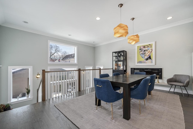 dining area with ornamental molding, dark wood-type flooring, and recessed lighting