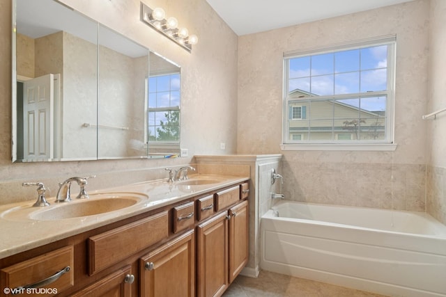 full bathroom featuring double vanity, a washtub, a sink, and tile patterned floors