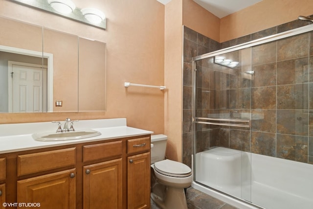 bathroom featuring toilet, a shower stall, tile patterned flooring, and vanity