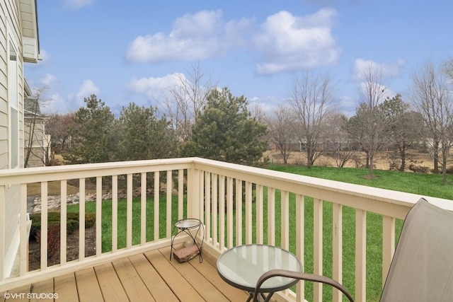 wooden terrace with a lawn