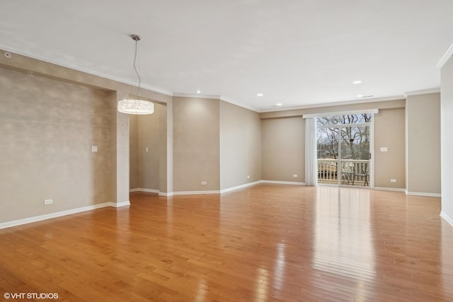 empty room with light wood-style floors, recessed lighting, ornamental molding, and baseboards