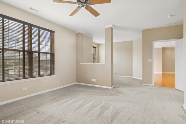 carpeted empty room with a ceiling fan and baseboards