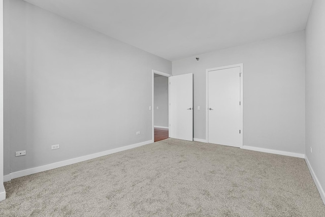 unfurnished bedroom with carpet floors and baseboards