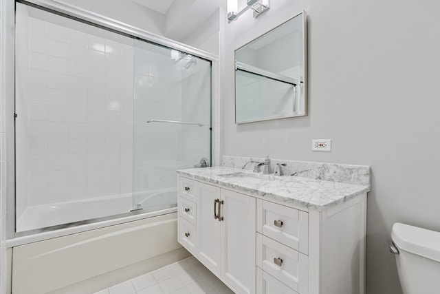 full bath with enclosed tub / shower combo, vanity, toilet, and tile patterned floors