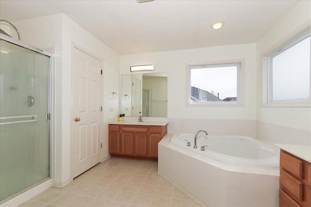 bathroom with a bath, tile patterned flooring, a shower stall, and vanity